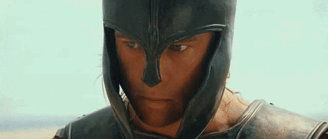 a close up of a man wearing a helmet and armor