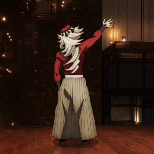 a man with long white hair and a red shirt is standing on a wooden floor