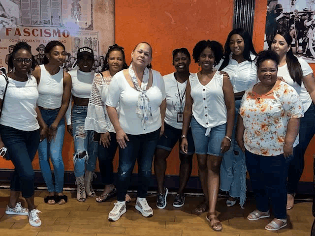 a group of women are posing for a picture in front of a poster that says fasismo