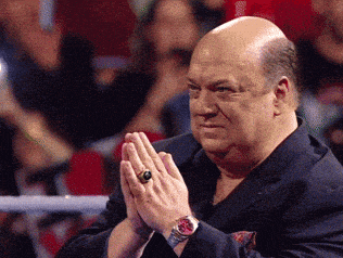 a man wearing a watch and a ring on his finger is clapping