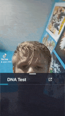 a young man is taking a dna test in a room with posters on the wall .