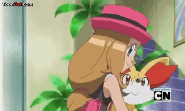 a girl in a pink hat is holding a small pokemon .