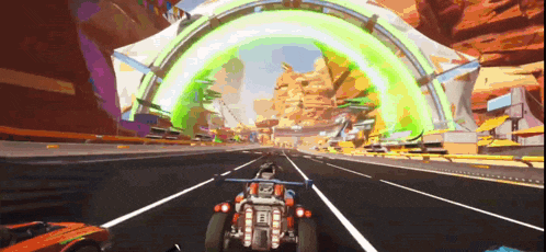 a car is driving down a road with a green archway in the background