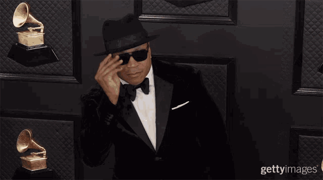 a man in a tuxedo giving a thumbs up sign
