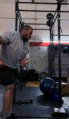 a man is doing exercises in a gym with a barbell