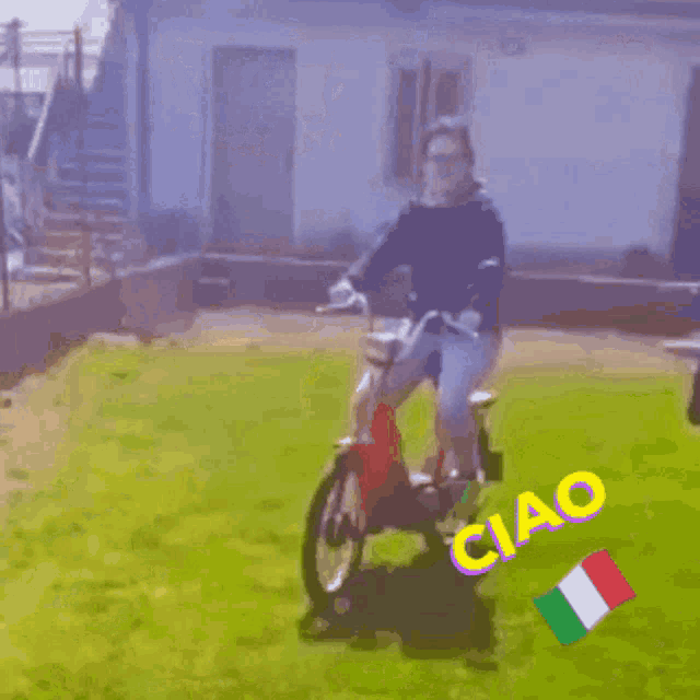 a person is riding a red scooter with the word ciao on the ground