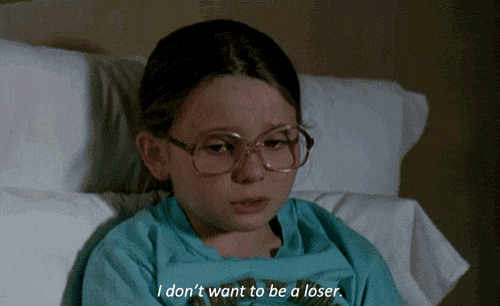 a young girl with glasses is laying in a hospital bed and says " i don 't want to be a loser "
