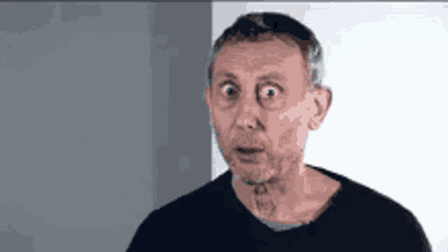a man with a beard is making a surprised face