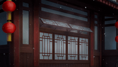 a red lantern is hanging from the side of a building next to a window
