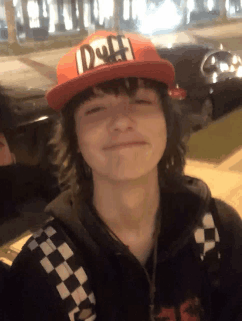 a person wearing a duff hat and a checkered shirt