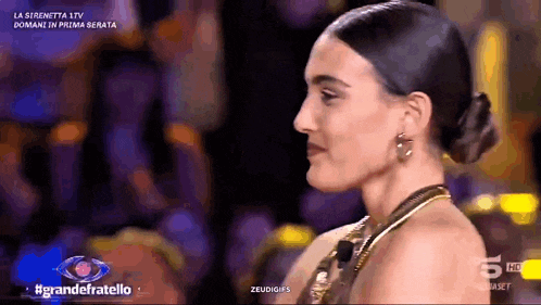 a woman with a bun on her head is on a tv show