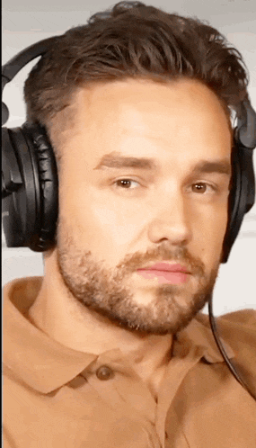 a man with a beard is wearing headphones