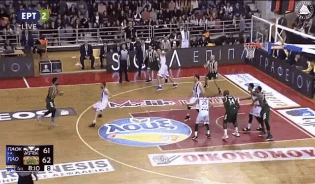 a basketball game is being played on a court that has an aqua logo on the floor