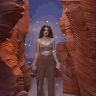 a poster for amaia el relampago shows a woman standing in the middle of a canyon