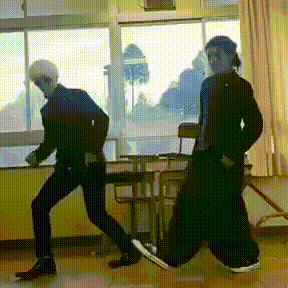 two people are dancing in a room with a window