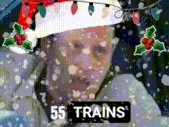 a man wearing a santa hat is surrounded by snow and the words 55 trains