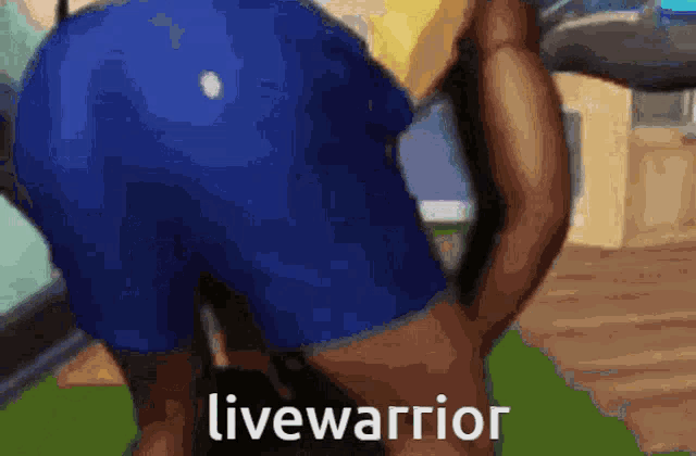 a man in blue shorts is squatting down with the words livewarrior written on the bottom of the image .