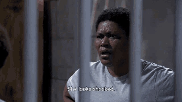 a man in a jail cell with the words she looks shocked