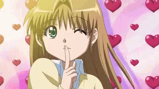 a girl is making a shhh gesture with her finger to her mouth .