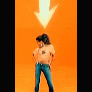 a woman wearing jeans and a crop top is dancing in front of an orange background .