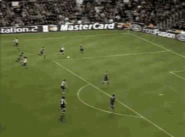 a soccer goalie stands in front of a playstation banner