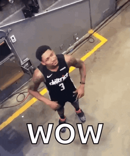 a basketball player with the number 3 on his jersey is standing in a parking lot