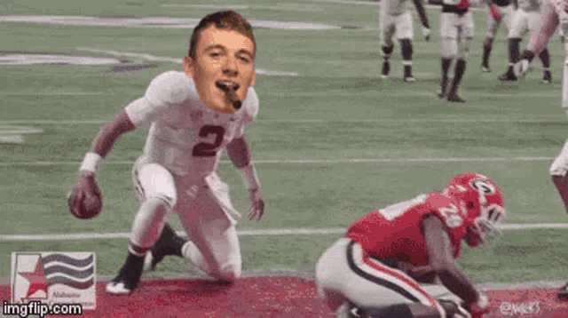 a football player with the number 2 on his jersey is kneeling on the field