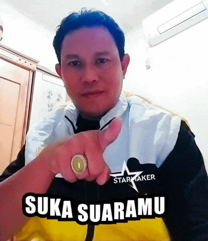 a man wearing a starmaker jacket is pointing