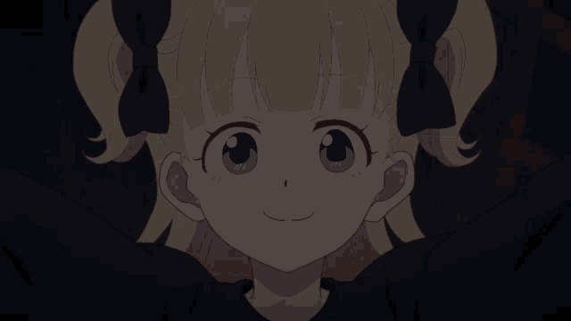 a girl with blonde hair and blue bows is laughing