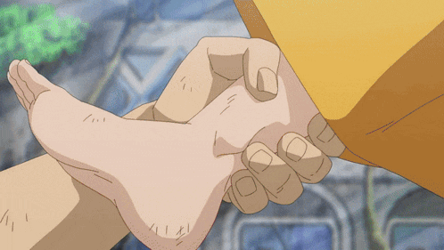 a person holding another person 's foot in their hand