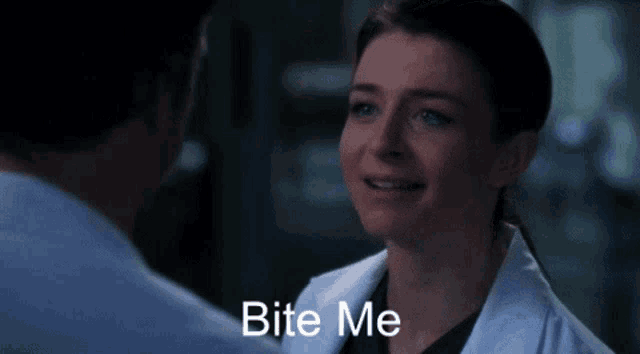 a woman in a lab coat says bite me to a man in a blue shirt