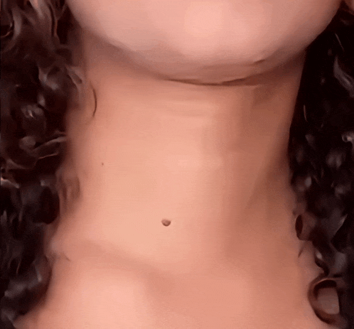 a close up of a woman 's neck showing a small hole in it