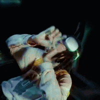 a person wearing a pair of goggles covering their face in a dark room .