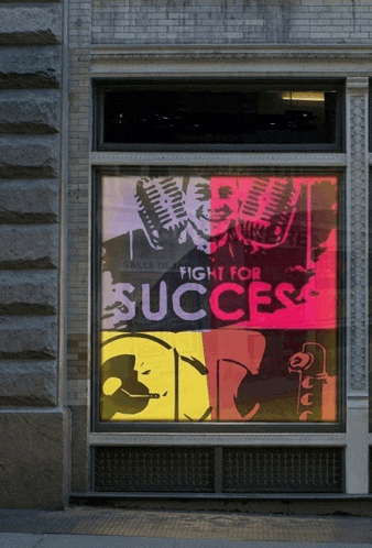 a sign in a window says fight for success