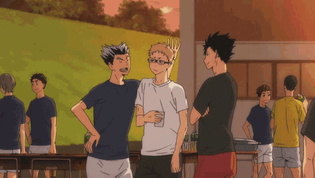 a group of people are standing around a table and one of them has a crown on his head