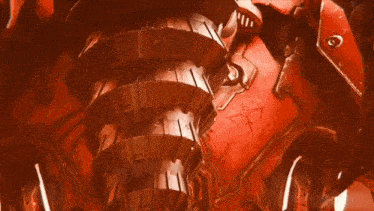 a close up of a red mechanical device with a few letters visible