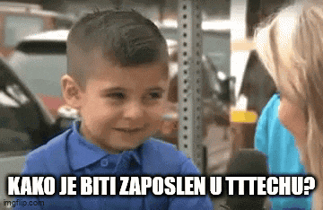 a little boy in a blue shirt is talking to a woman in a parking garage .
