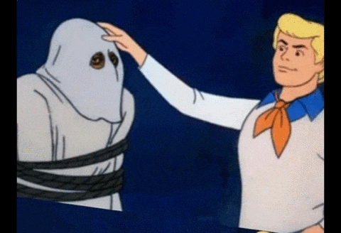 scooby doo is putting his hand on a ghost 's face