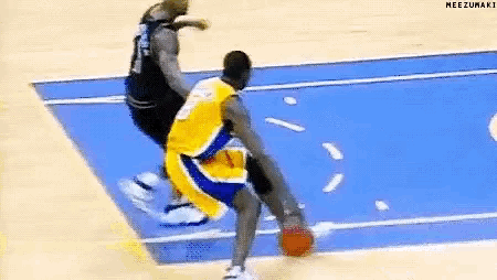 a basketball player in a yellow jersey is dribbling the ball on a blue court .