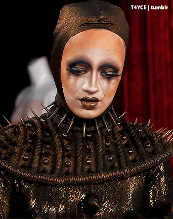 a close up of a person wearing a hat with spikes