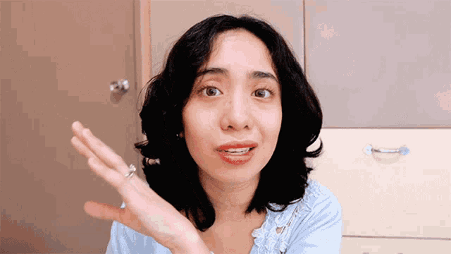 a woman with a ring on her finger is making a gesture
