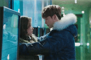 a man and a woman are hugging each other and kissing .