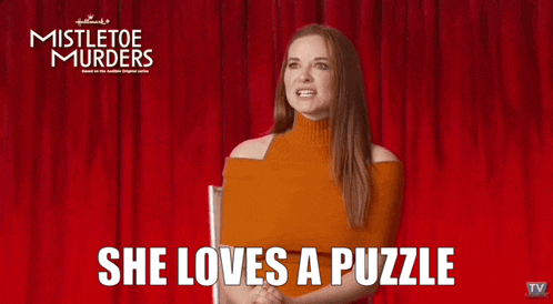 a woman says she loves a puzzle in front of a red curtain with mistletoe murders written on it