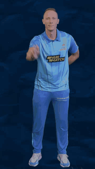 a man in a blue shirt with pari match on it