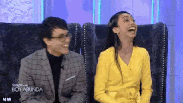 a man and a woman are sitting next to each other on a couch with the words tonight with boy abunda on the bottom