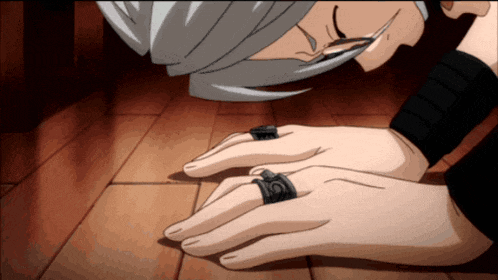 a person with a ring on their finger that has the letter o on it
