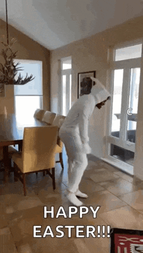 a person in a white bunny costume is dancing in a dining room .