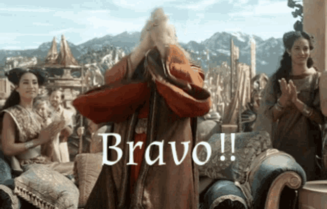 a man in a red robe is standing in front of a group of people and the word bravo is above him