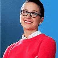 the woman is wearing glasses and a red sweater .