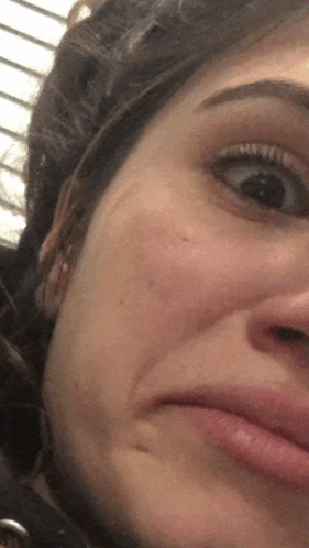 a close up of a woman 's face with a slight smile on her face .